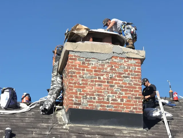 Medfield Chimney Sweep installing a custom chimney crown in Medfield, MA