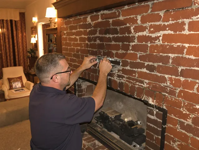Medfield Chimney Sweep expert fixing a fireplace in Medfield, MA
